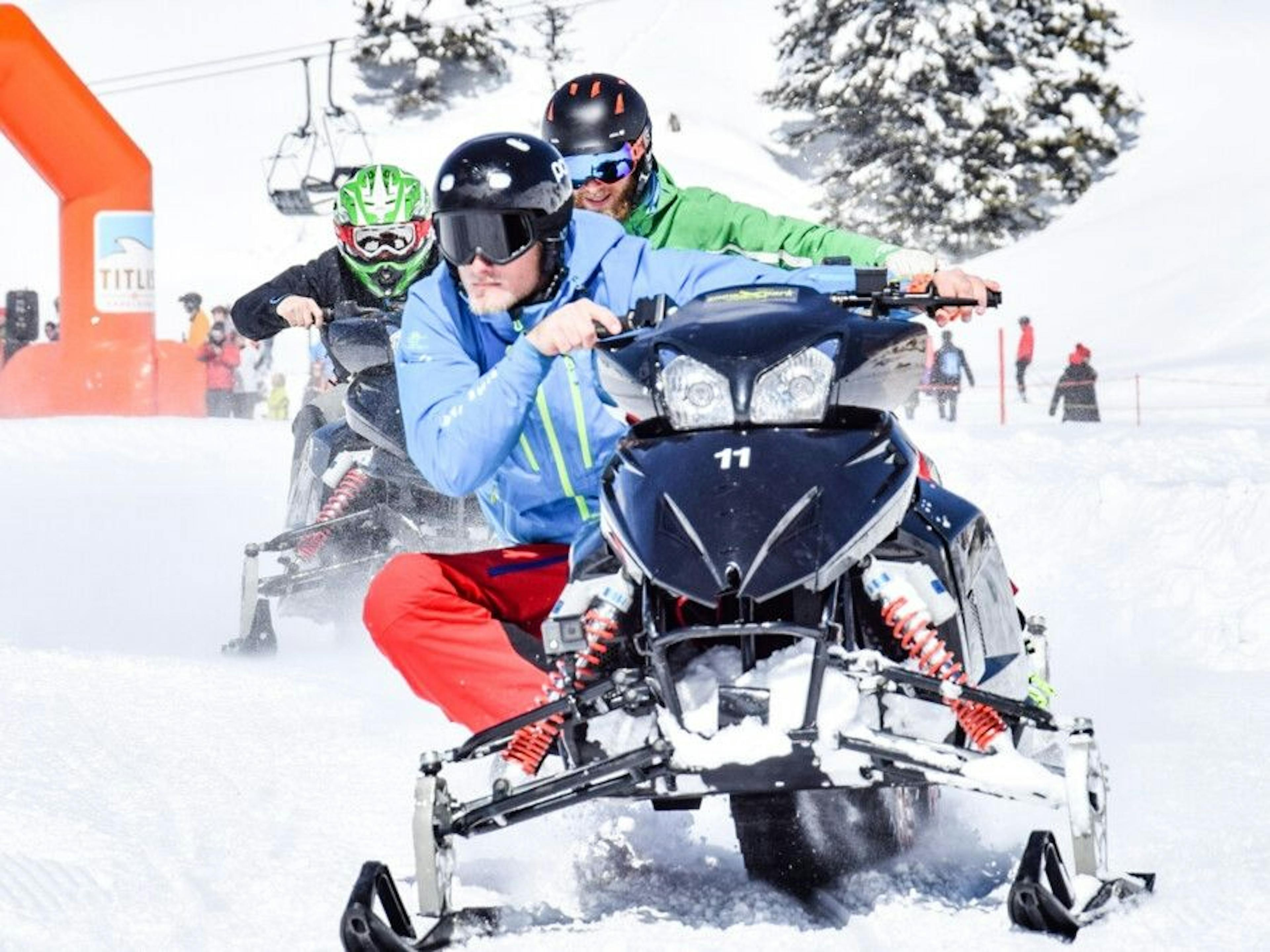 Rent snowmobiles Titlis, driver in warm clothing, snow-covered landscape