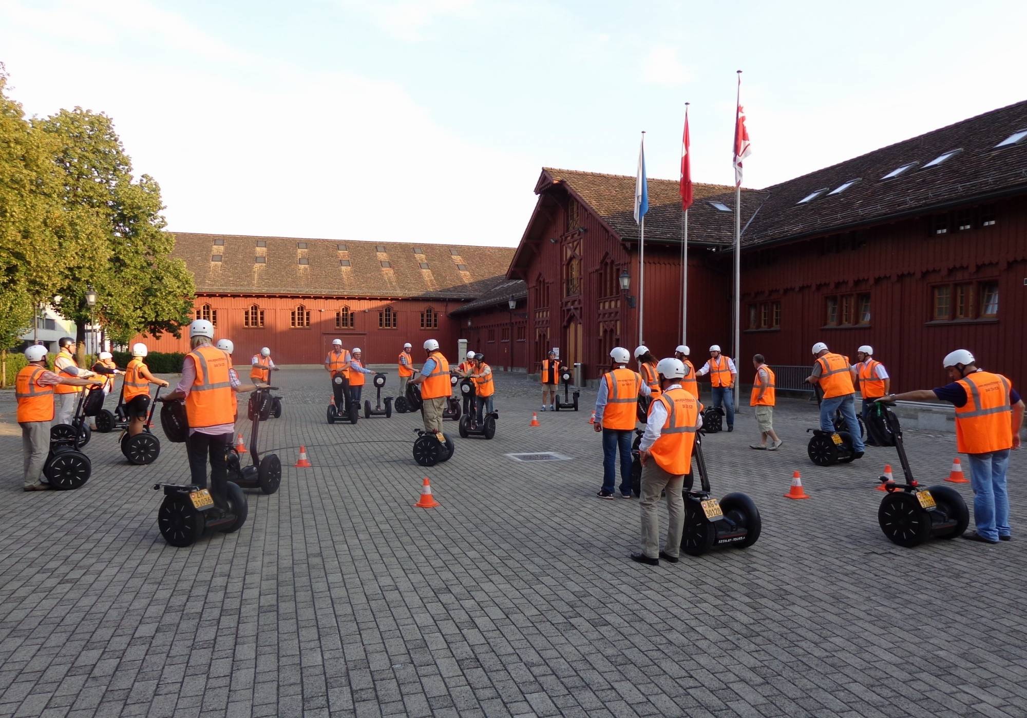 Ξεναγήσεις με Segway στο Winterthur με ομάδα ντυμένη πορτοκαλί.|