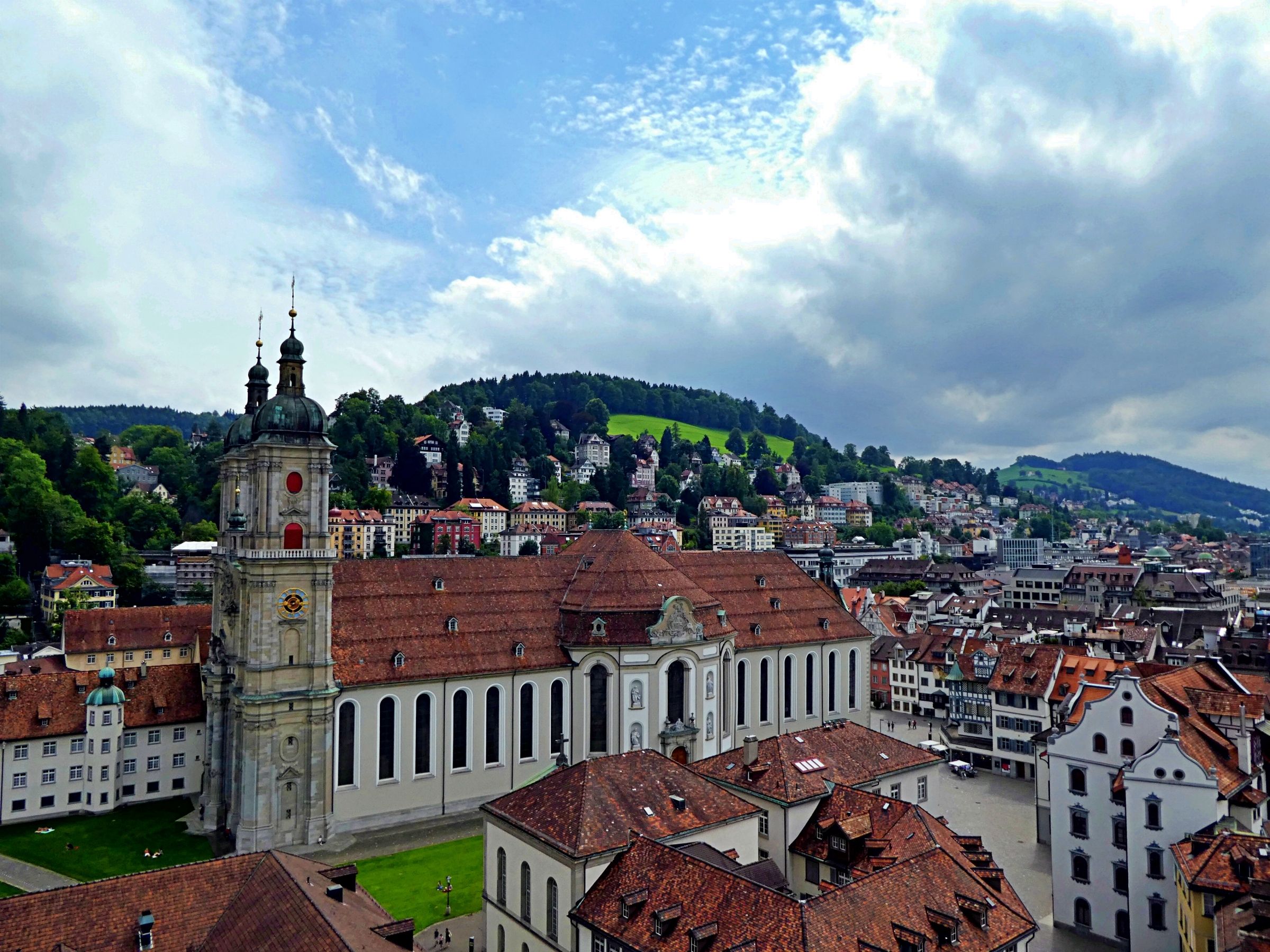 St. Gallen with a view of the abbey church and mountains, cloudy sky.