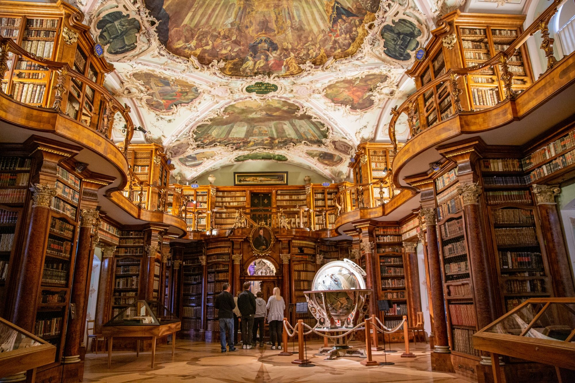 Stiftsbibliothek interior view with bookshelves and globe