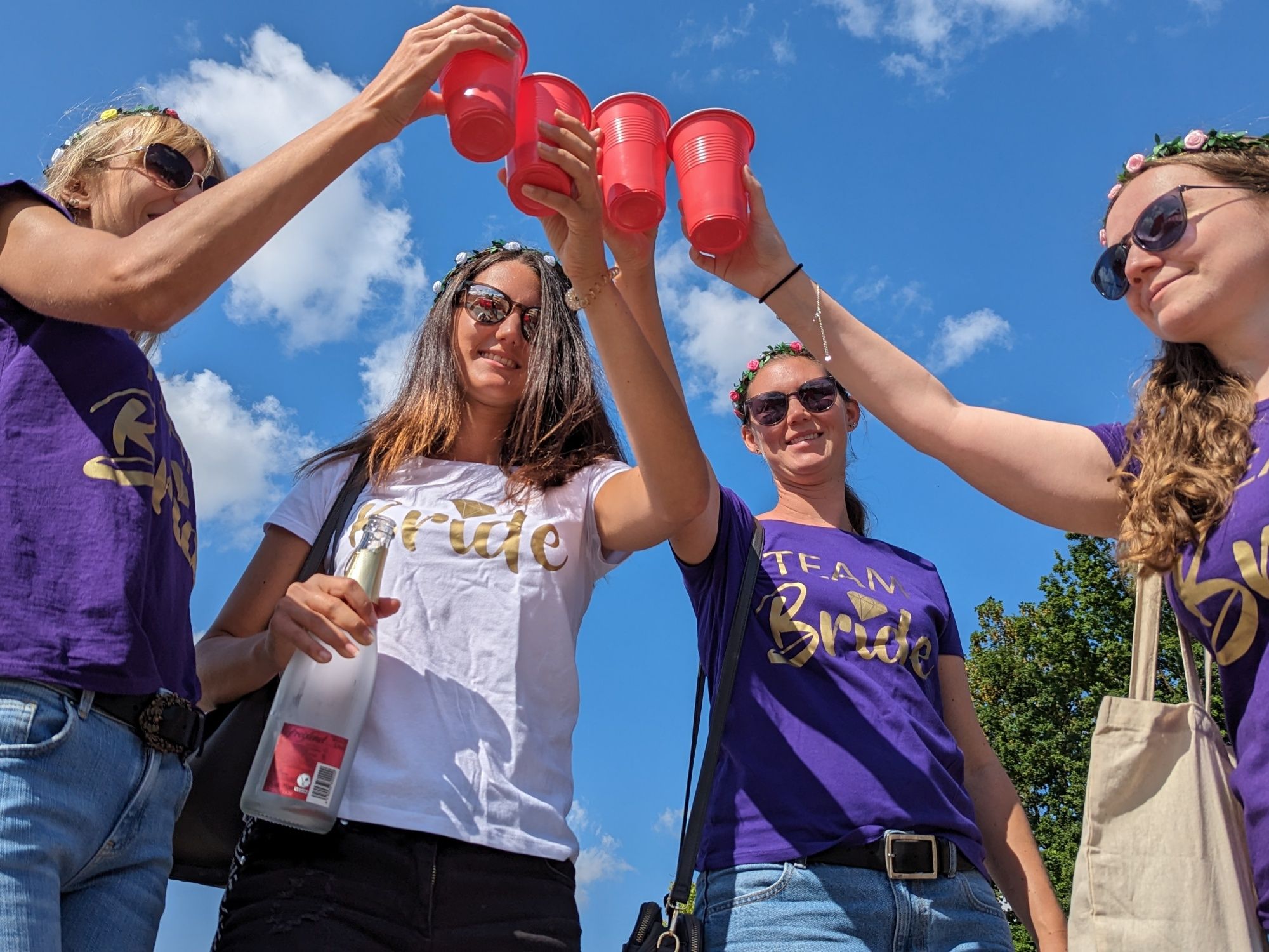 Bachelorette Party: Friends Celebrating with Drinks Under Blue Sky