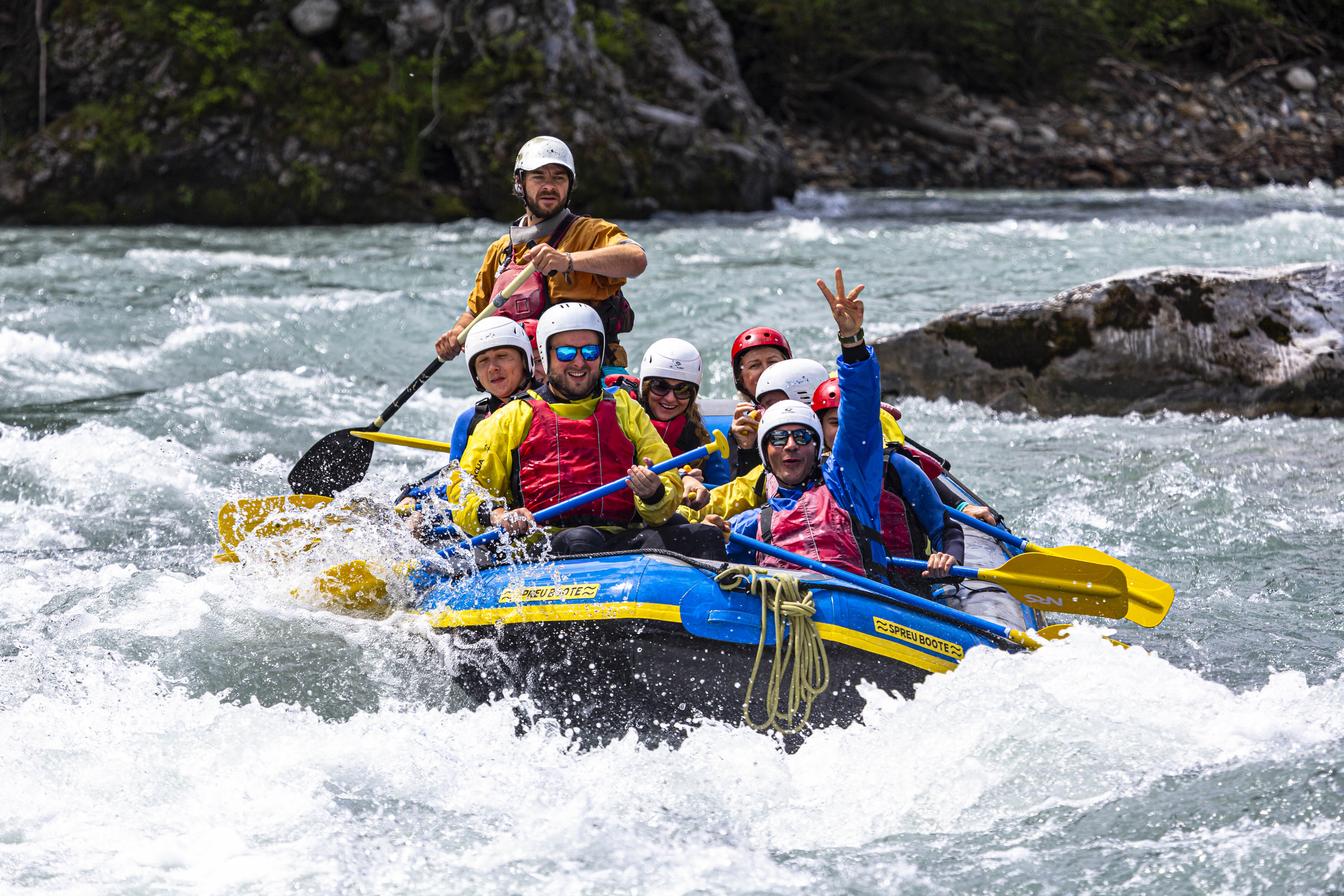 River rafting Rheinschlucht with several people in the boat actively paddling
