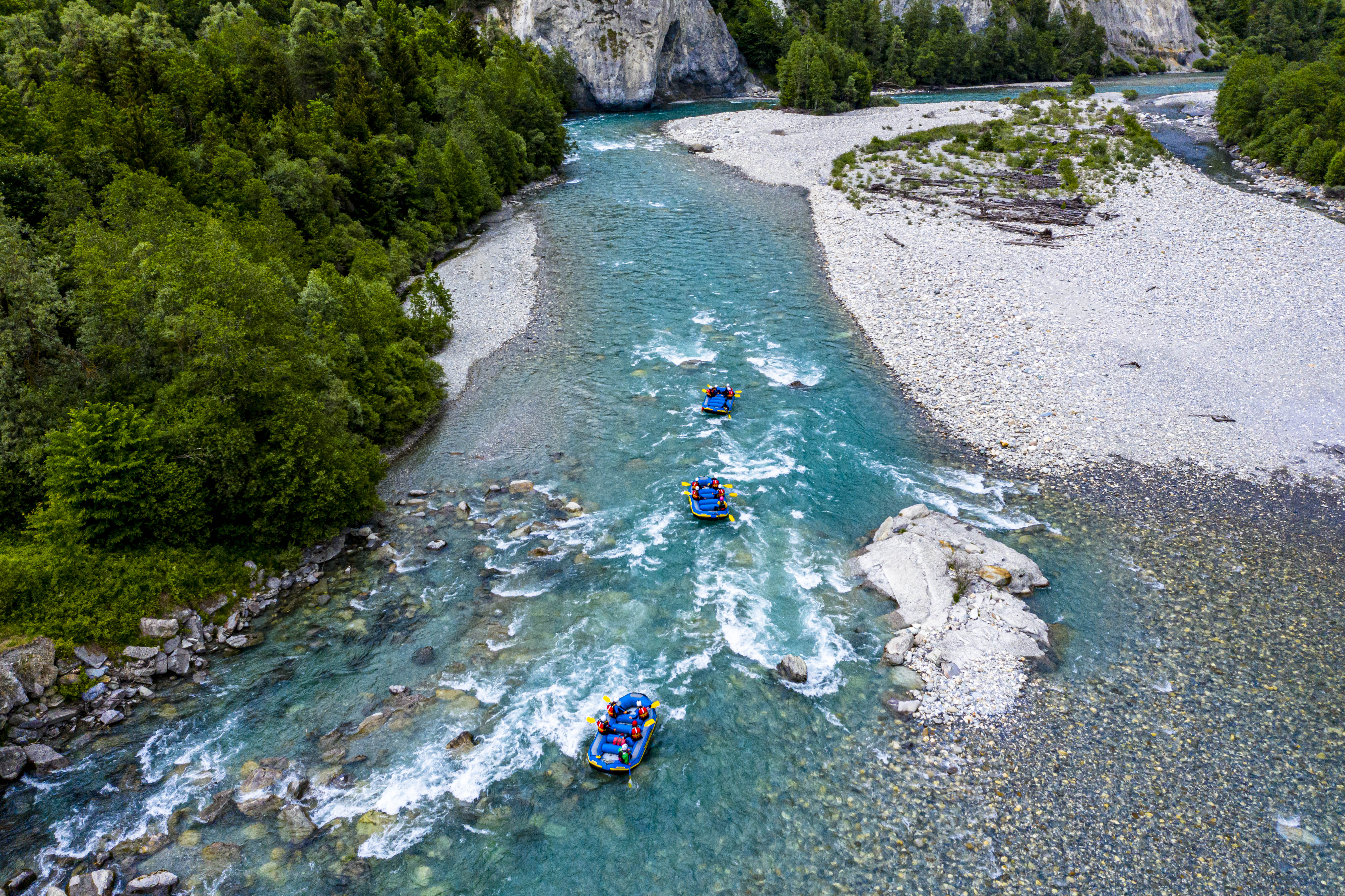 Rafting Vorderrhein in 2023, boats on the clear water, surrounding forests