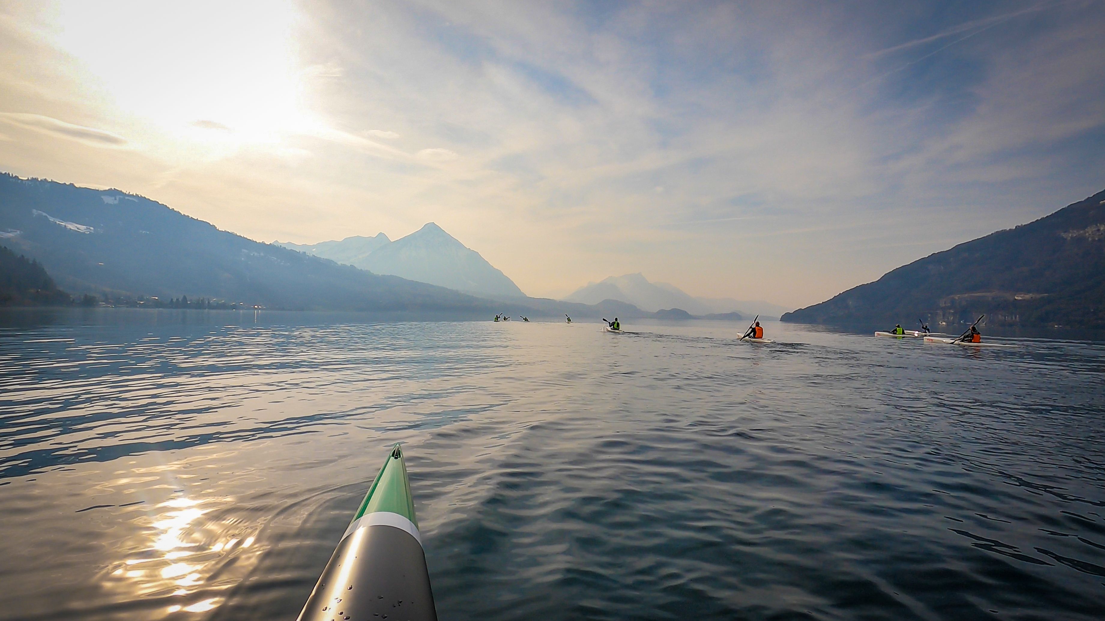Πεζοπορία με σανιδοδάσος σε ήρεμα νερά, βουνά στο υπόβαθρο, φυσικός φωτισμός