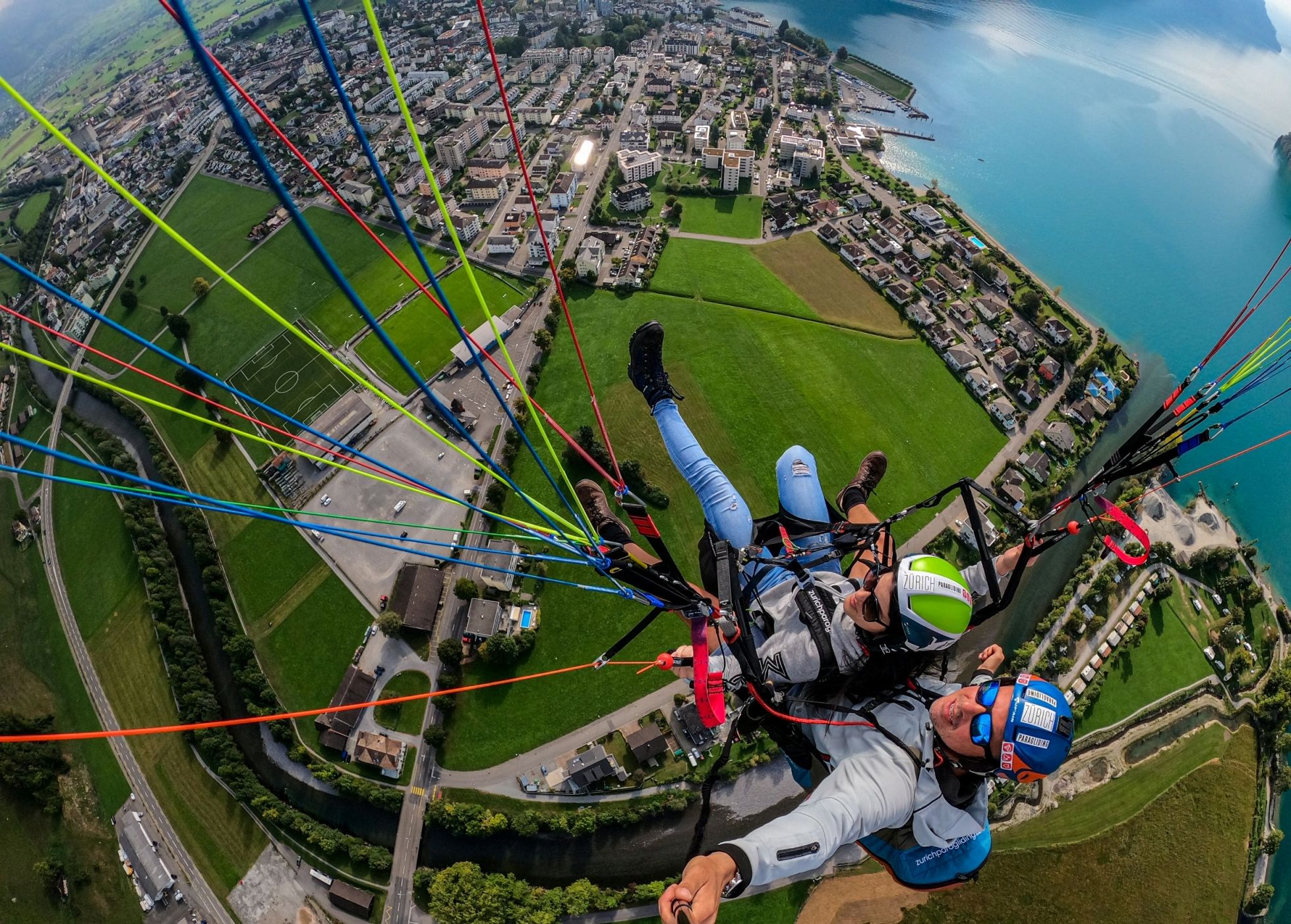 Voo de parapente em Urmiberg sobre Zurique, vista da cidade e áreas verdes.