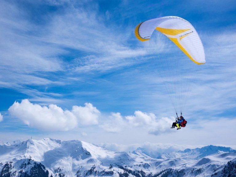 Paragliding Tandem Flight over Snow-Covered Mountains