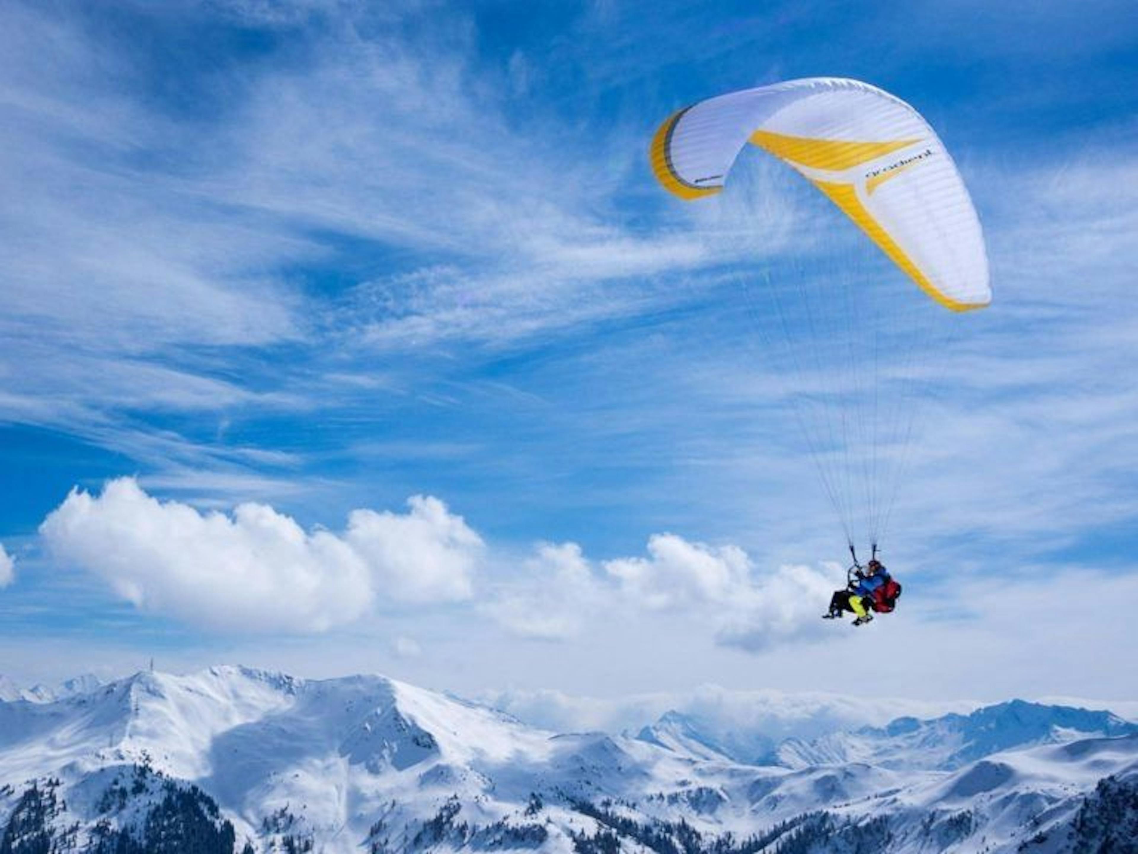 Paragliding Tandem Flight over Snow-Covered Mountains