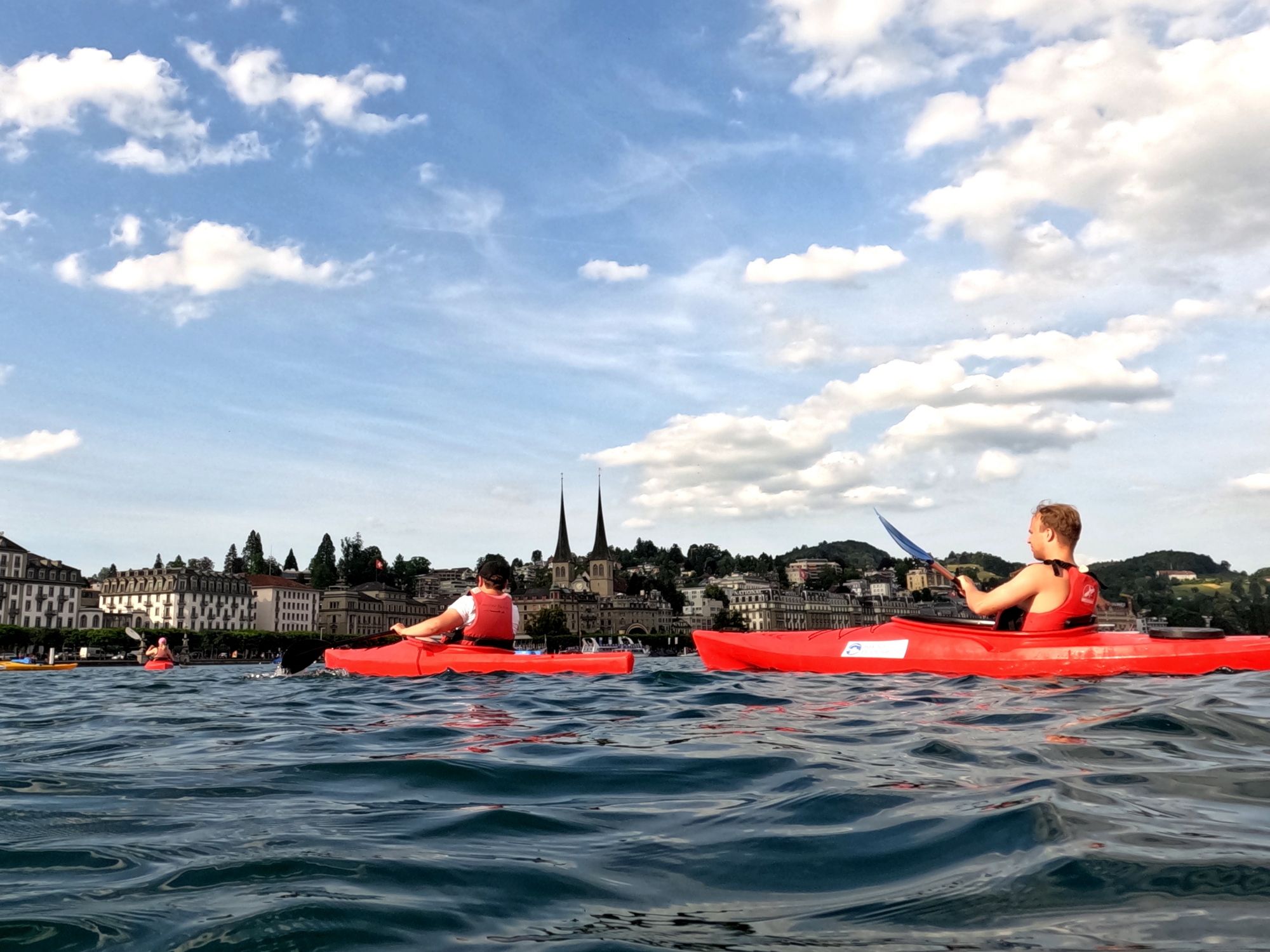 Sea kayak tour on Lake Lucerne with kayaks and views of the city of Lucerne.