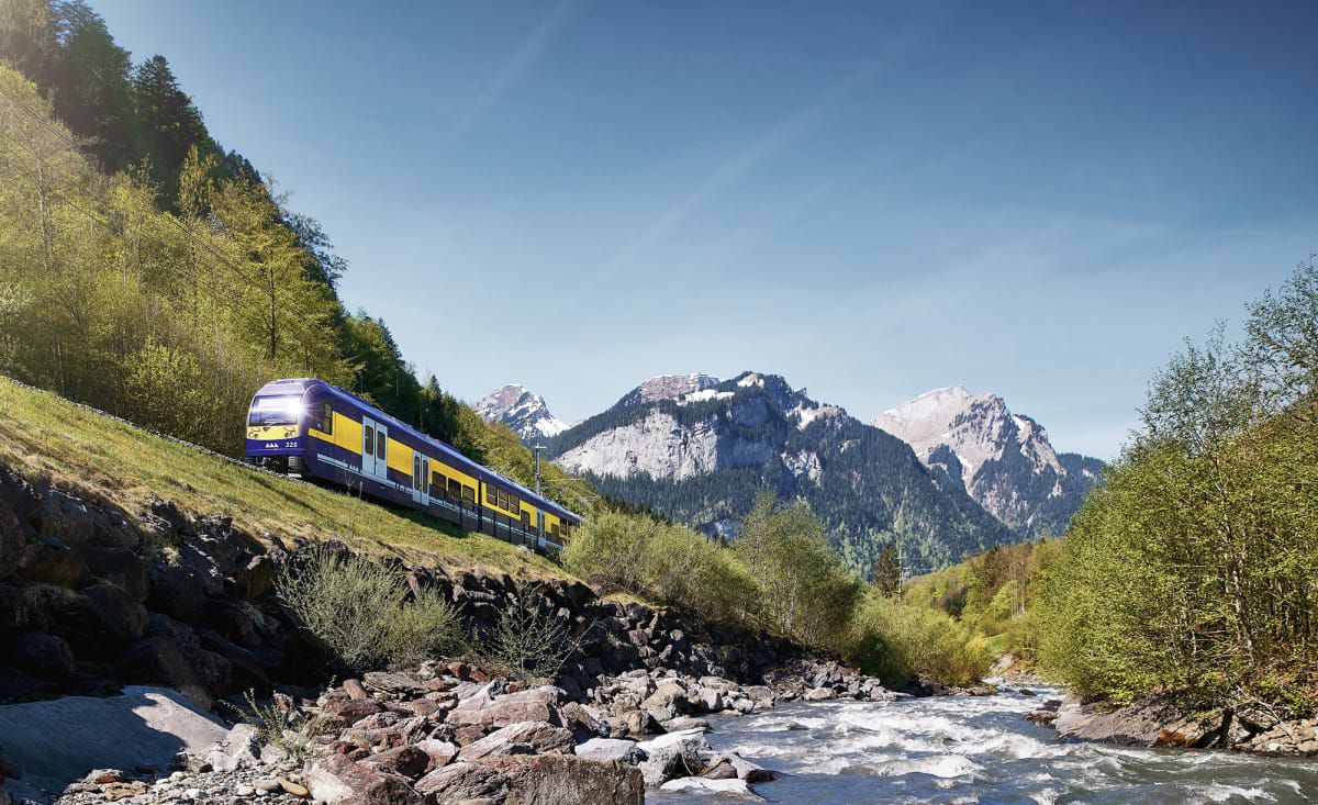 Berner Oberland Railway: Experience the picturesque nature along the route in summer with mountains and river.