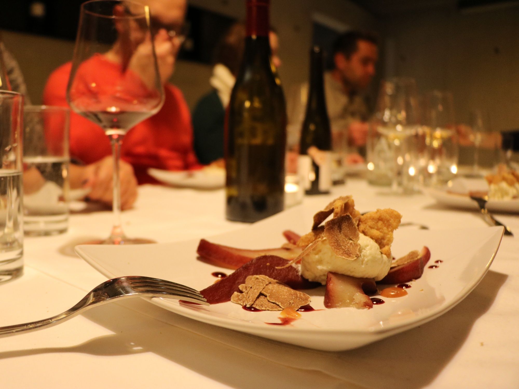 Eten: Geniet van een subliem gerecht met wijn en vrienden in een elegant restaurant.