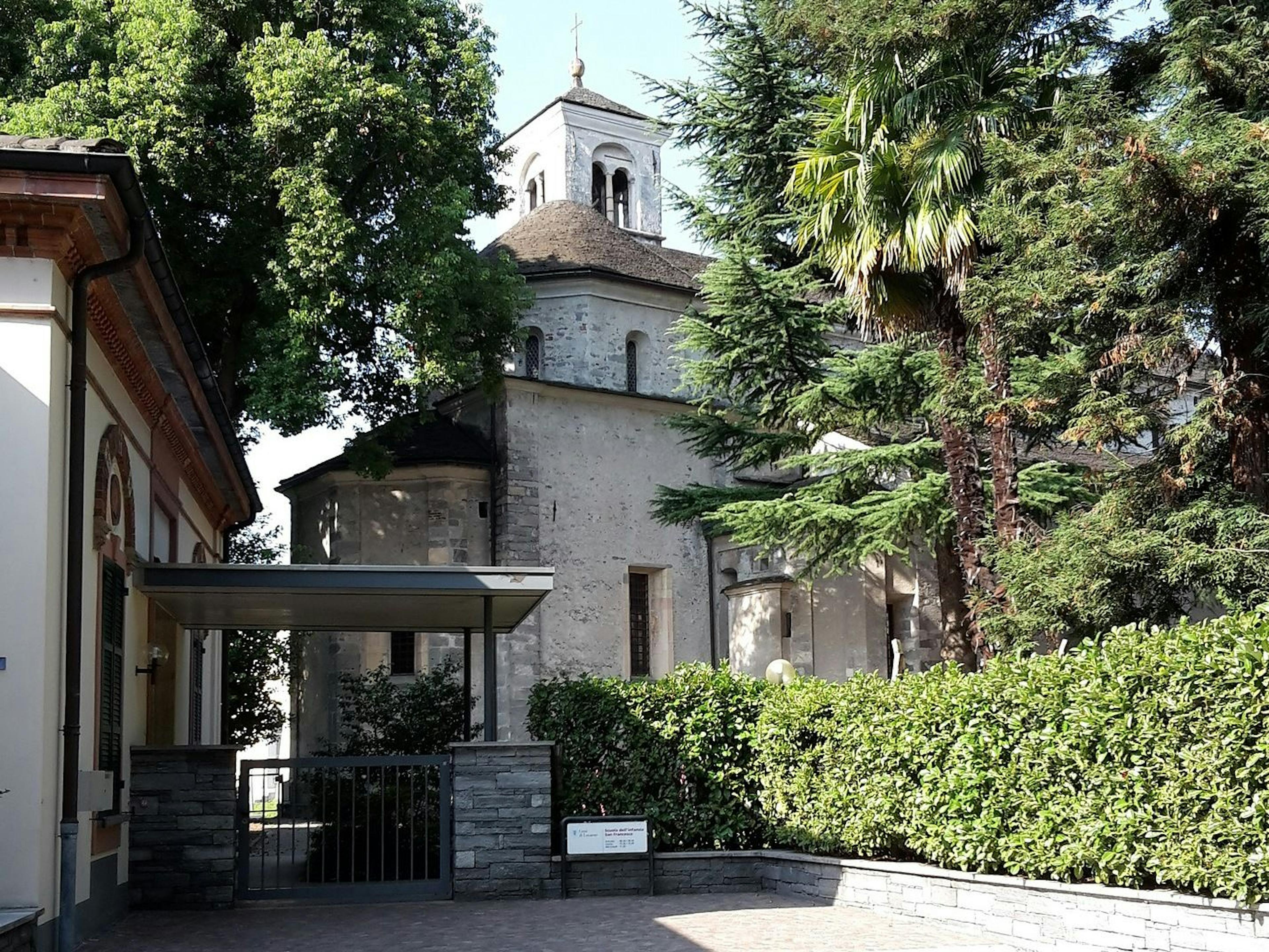 Church in Locarno with trees, ideal for romantic outings and group activities.