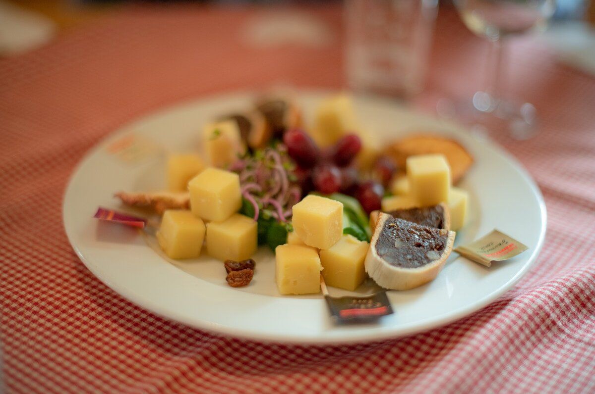 Cheese platter at cheese tasting in Appenzell with grapes.