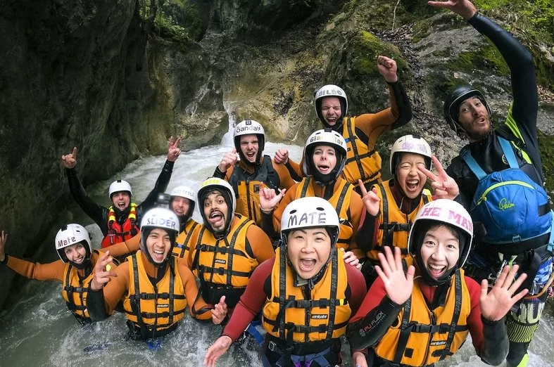 Canyoning Interlaken: Group of people engaging in water sports in a rugged environment.