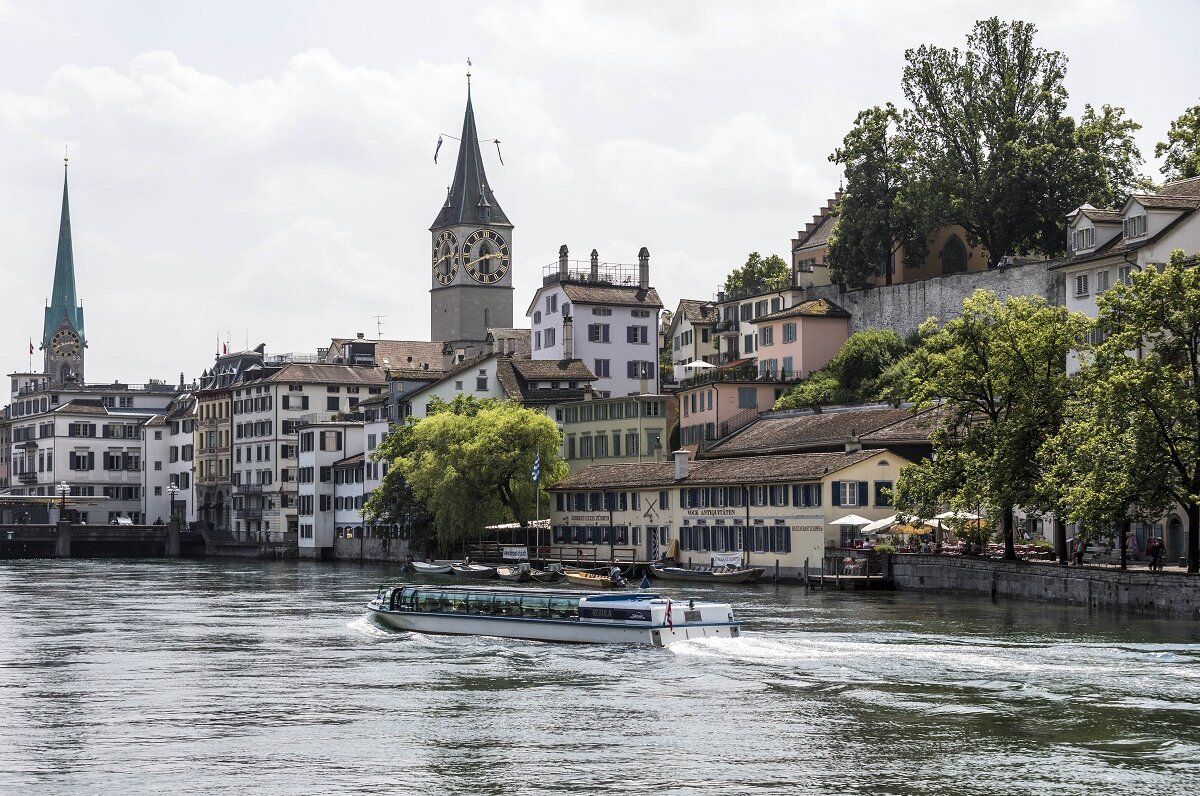 Zürich Limmat med både båte og byudsigt, sommeren 2023.