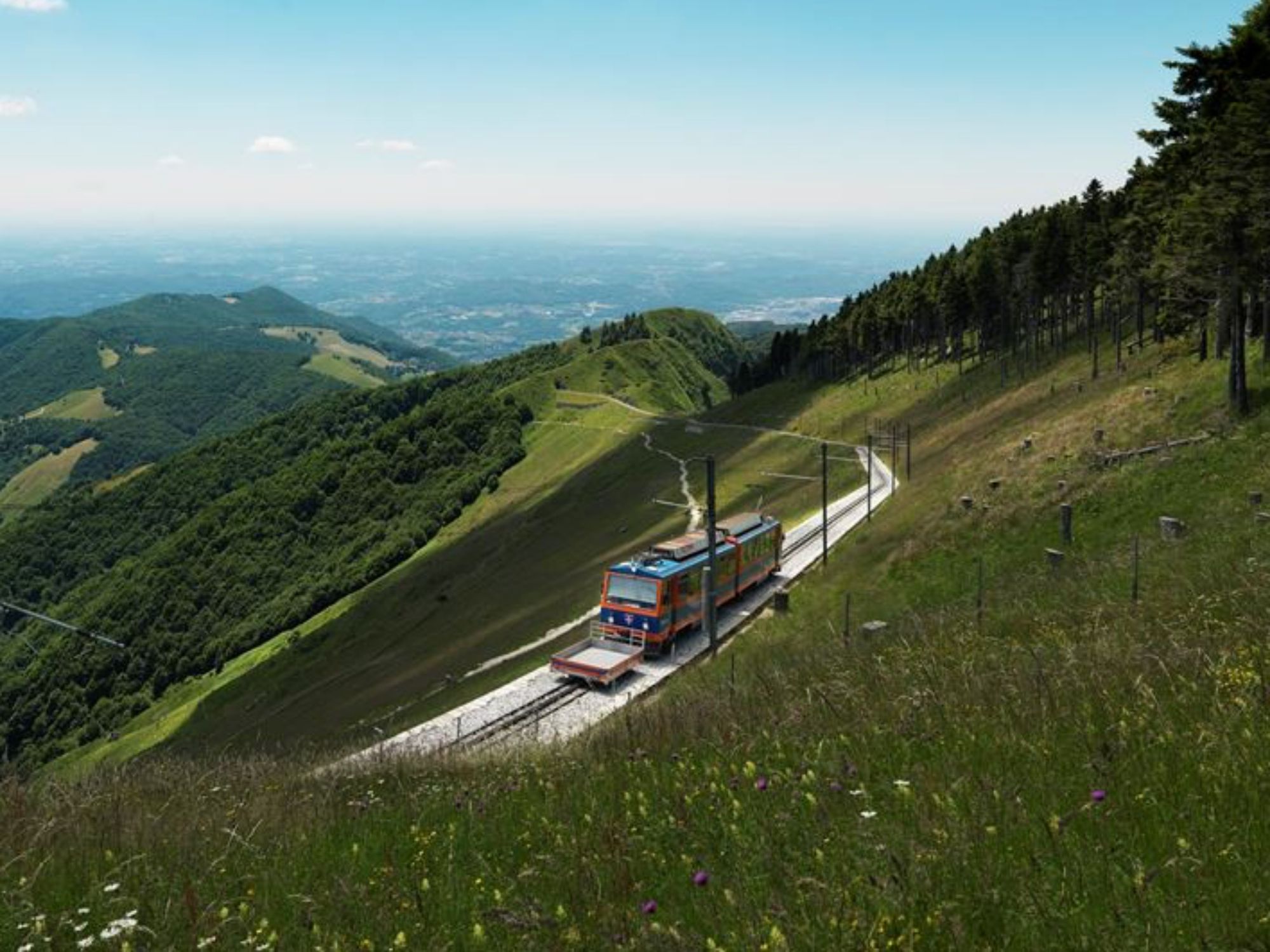 Monte Generoso: View of the train in the greenery with fresh air, perfect for trips into the mountains.