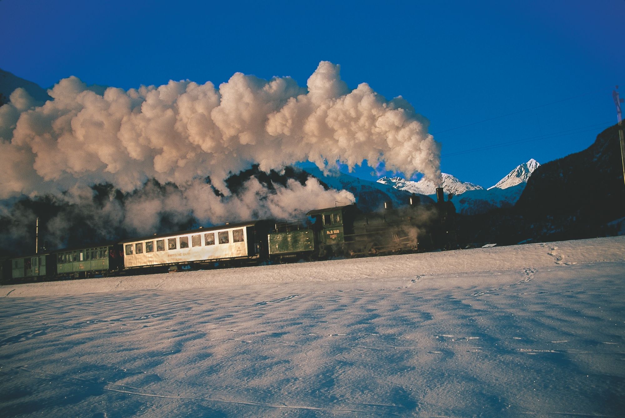 Engadin steam journey steam locomotive travels through snow in the Engadin.