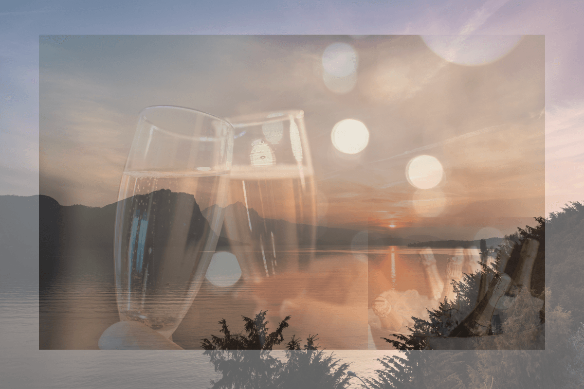 Sunset at a romantic champagne celebration on a boat with a view of the water and the mountains.