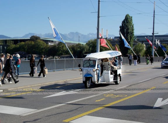 Tuk Tuk: Verkehr auf der Seebrücke mit Aussicht auf die Berge und fröhlichen Menschen.