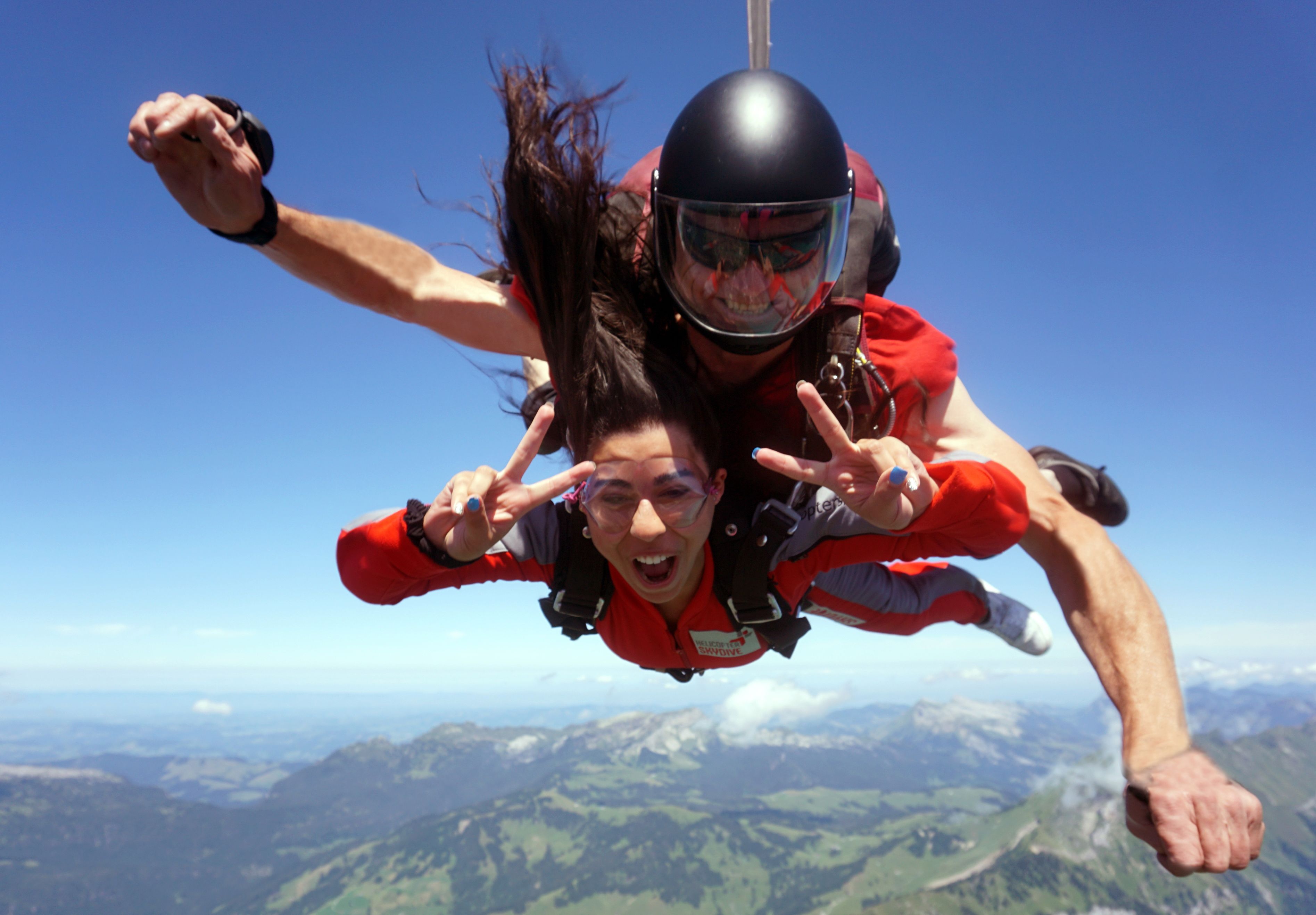 Free fall during a parachute jump over Bern, mountain scenery and blue sky