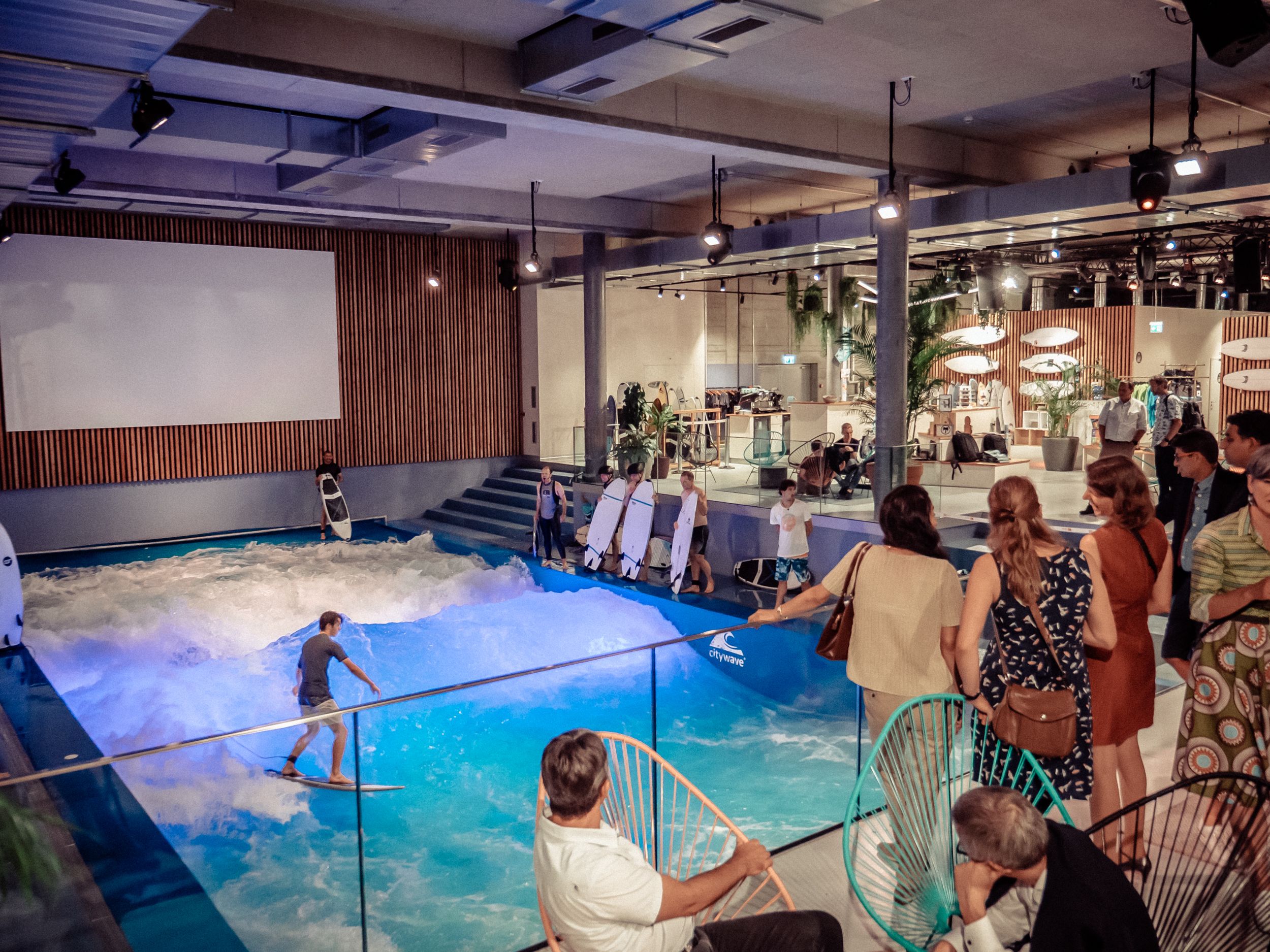 Oana Surf audience while surfing in modern surroundings.