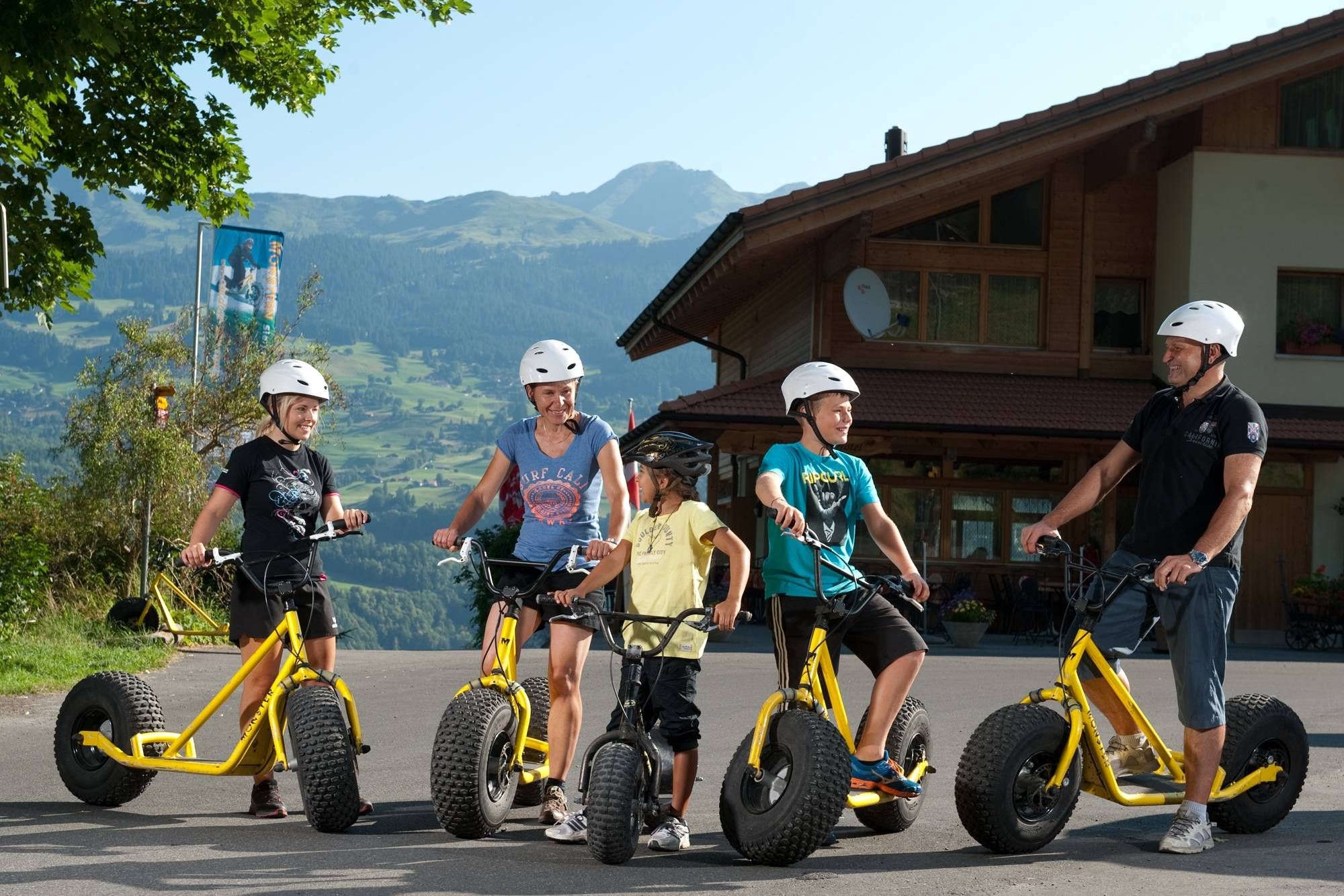 Monster Scooter Tour Start with Group Activity in Mountain Landscape.