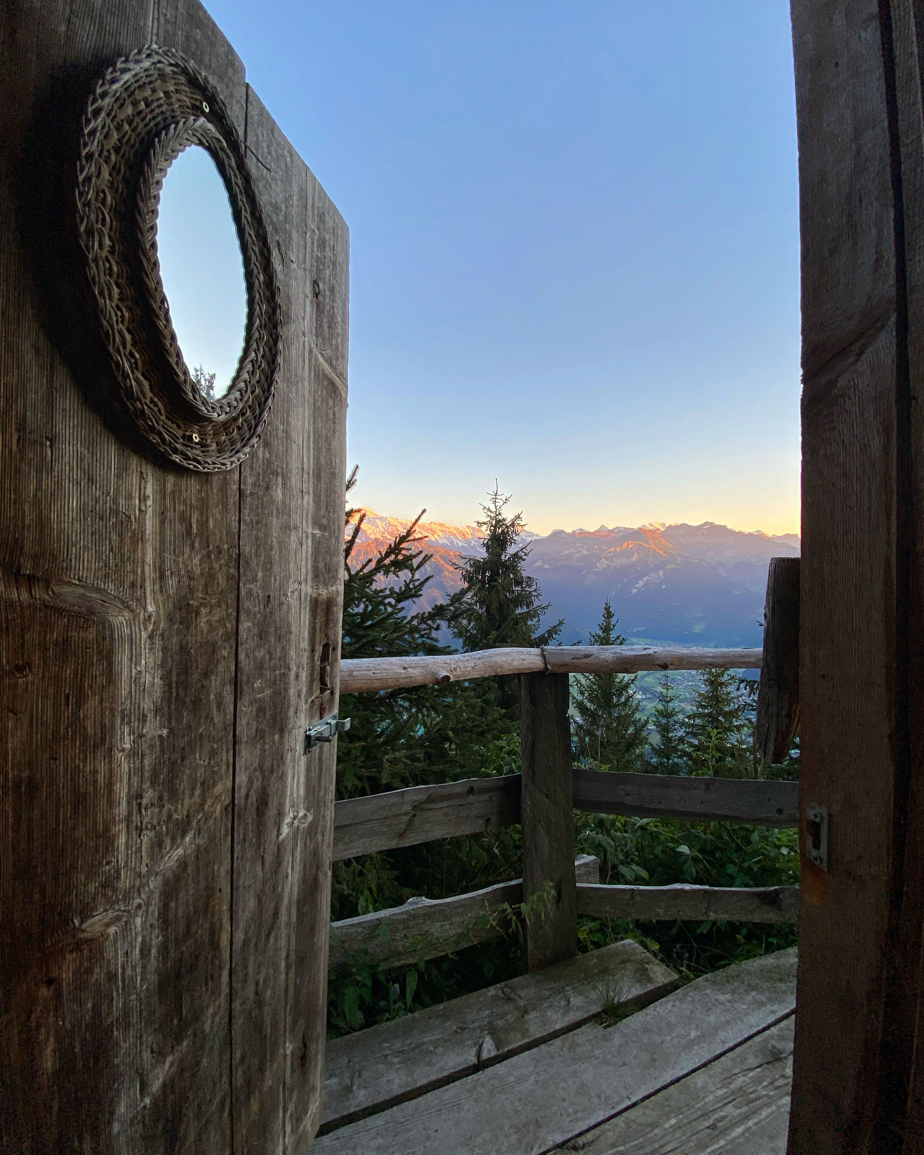 View from a wooden door of the mountains in Lauterbrunnen