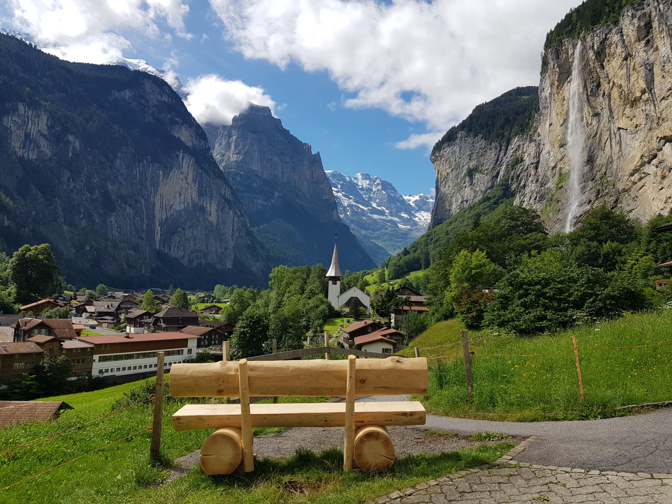 Lauterbrunnen with a view of mountains and church, surrounded by green meadows