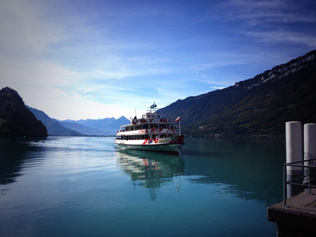 Boat on the lake, surrounded by mountains and gorges
