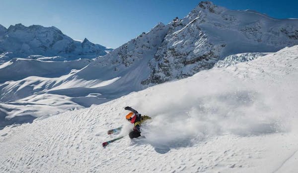 Heliski skier deep snow