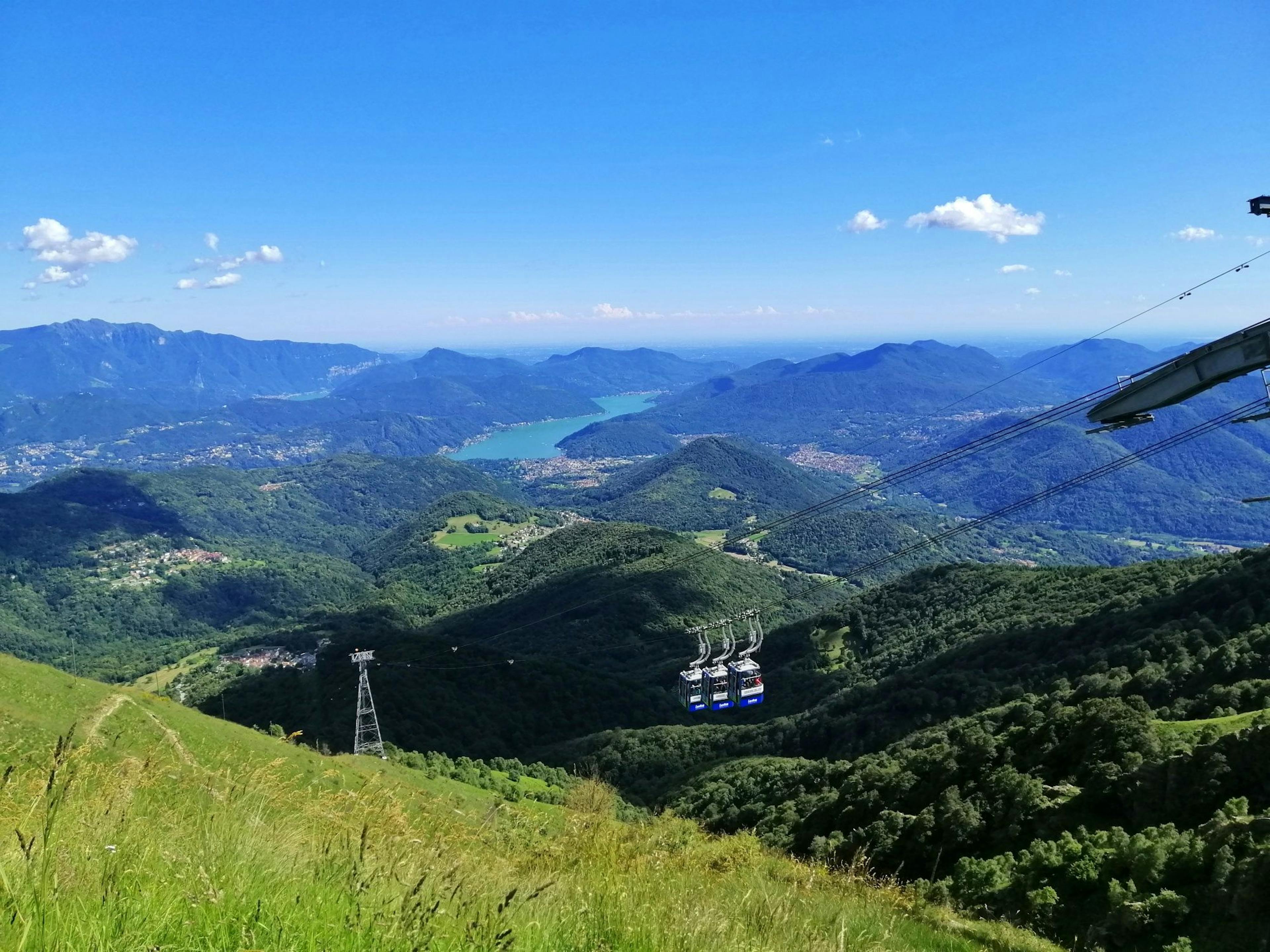 Funivia Monte Lema: vista mozzafiato su montagne, natura e il Lago di Lugano.