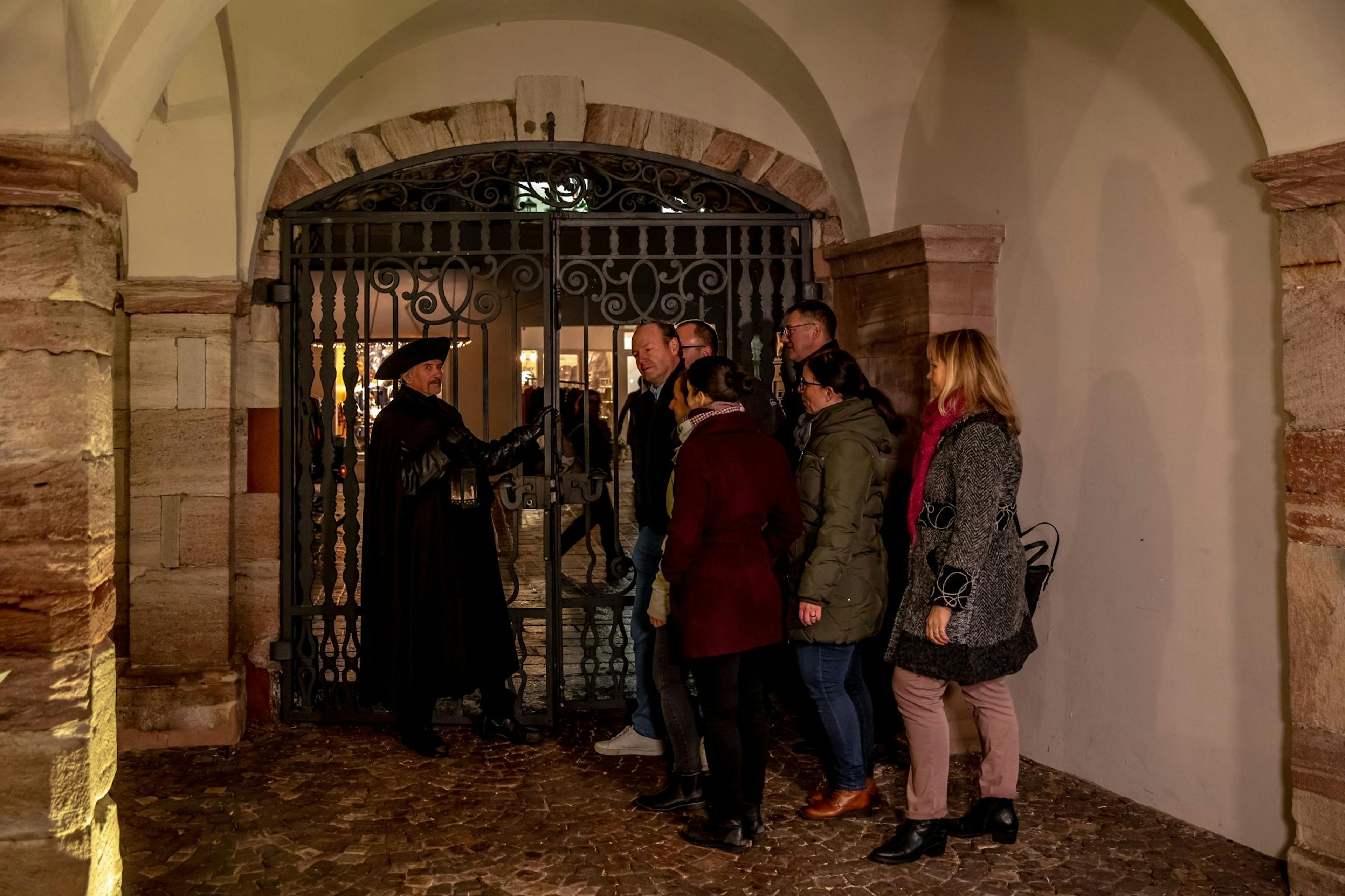 Night watchman and group during city tour in Rheinfelden