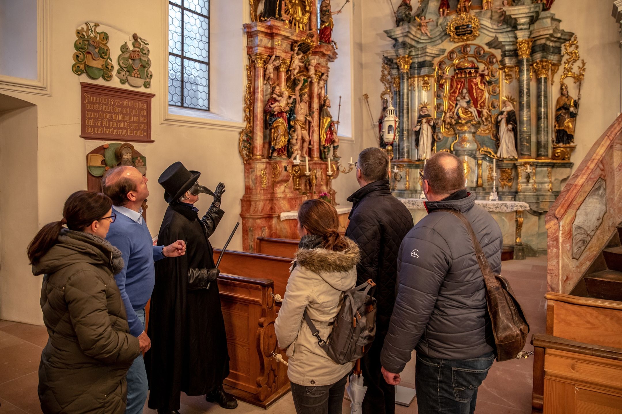 Pest altar in Rheinfelden during city tour, visitors view art