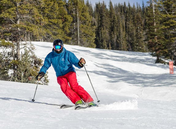 skiløber: Skiløber i rød udstyr nyder et kursus i sneen ved Sports Paradise.