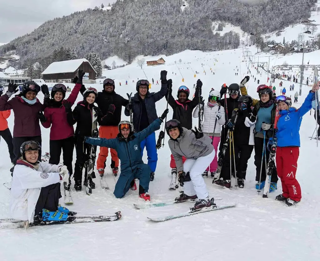 Ski school: group training on the piste with enthusiastic participants in winter.