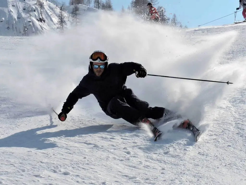 Ski school: Active skier on a snowy slope during a winter holiday, experiencing skiing and snow.