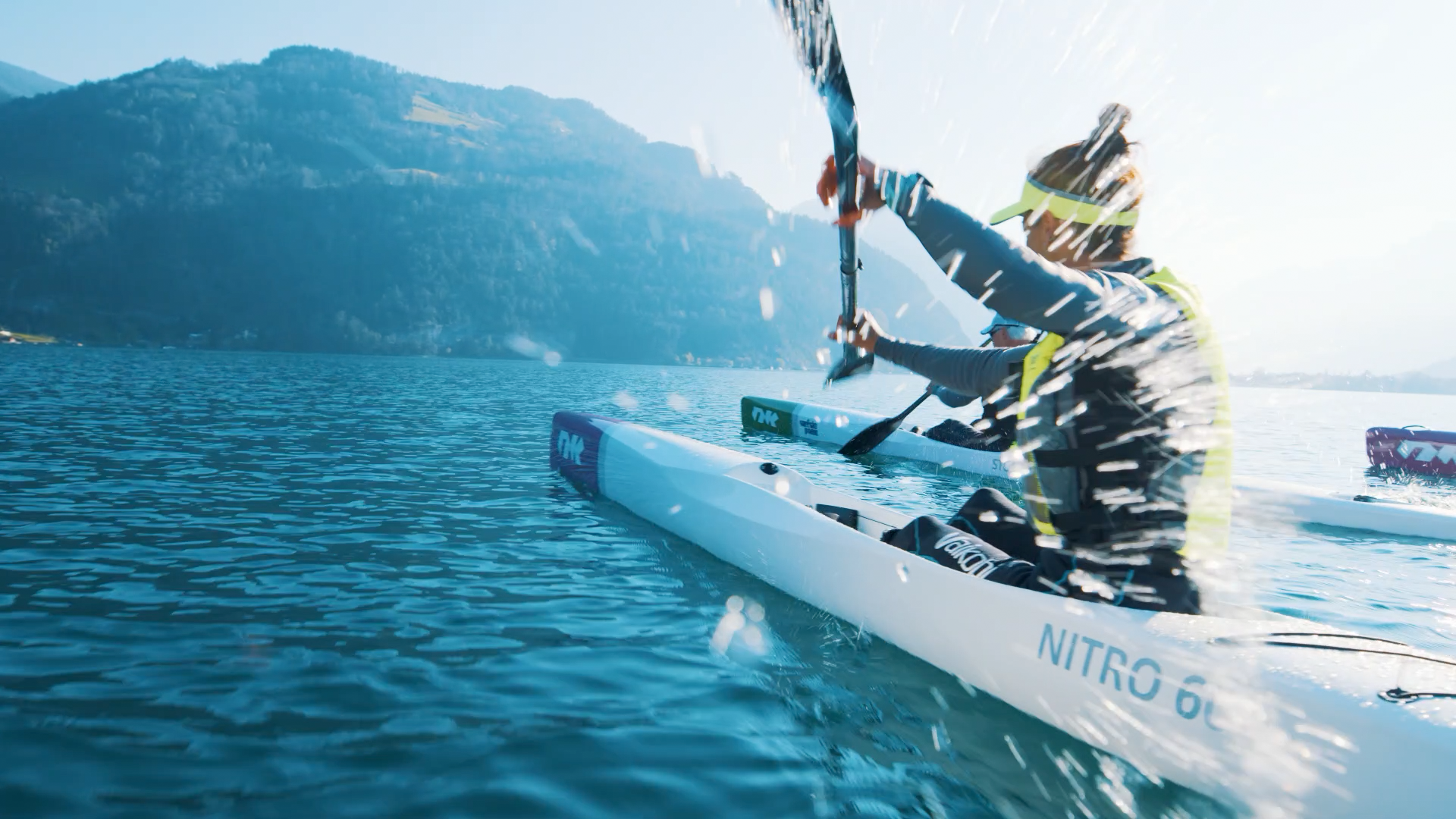 アルプスの前の湖でのスプラッシュのエンターテイメントを伴うサーフスキーケ kayak