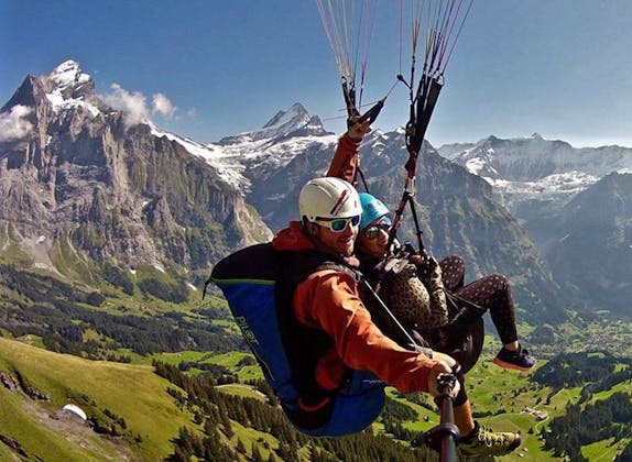 Paragliding in Grindelwald over the Eiger North Face, relaxing view, mountain landscape.