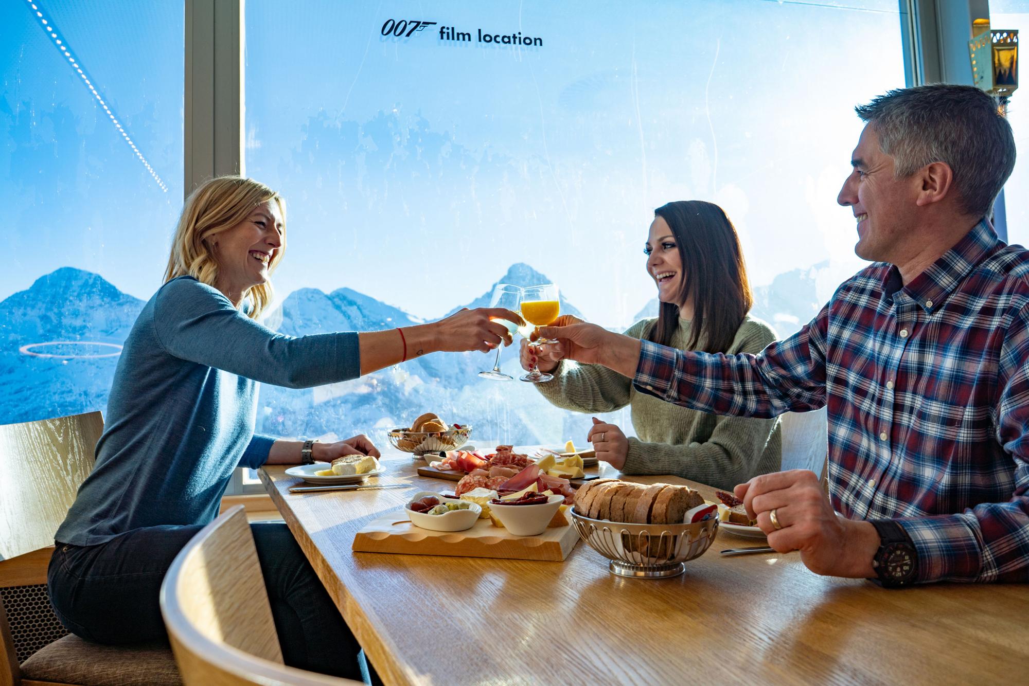 Piz Gloria Zvieri con personas brindando y disfrutando de platos regionales